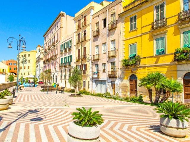 Brightly painted buildings on boardwalk in Sardinia, Italy