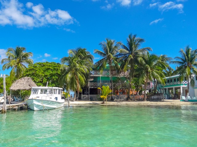 Boat docked in front of homes on Caye Caulker, Belize