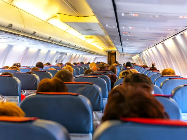 Economy-class section of airplane, looking back to front