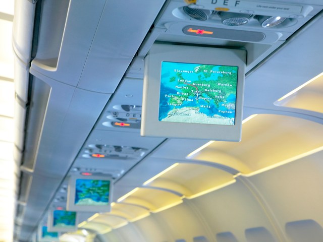TV monitors above seats in airplane
