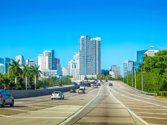 Cars on highway with view of Miami skyline