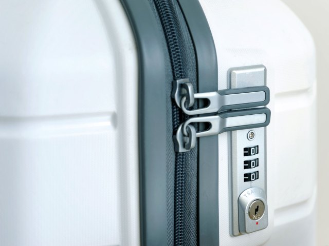 Close-up view of zipper and luggage lock on suitcase