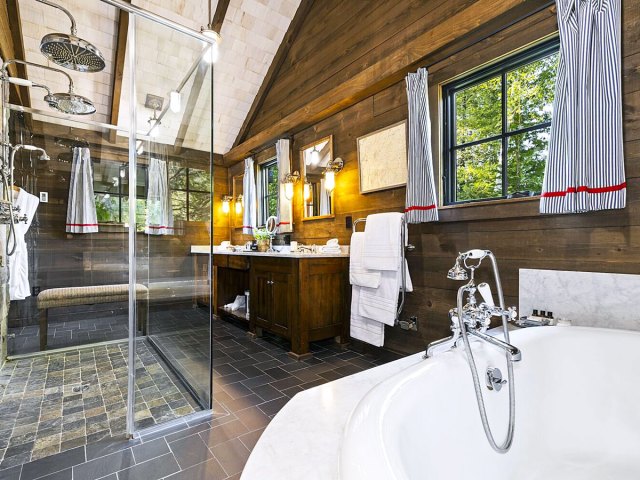 Spacious bathroom with tub and rain shower at the Point in Saranac Lake, New York