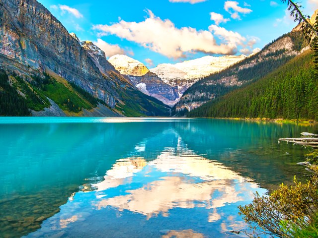 Reflections of clouds and mountains on Lake Louise in Alberta, Canada