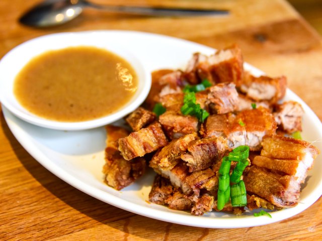 Plate of lechon with dipping sauce