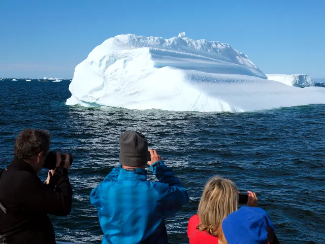 Tourists photographing iceberg in Greenland