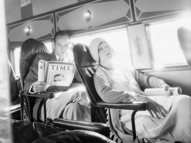 Passenger reading Time magazine on early flight