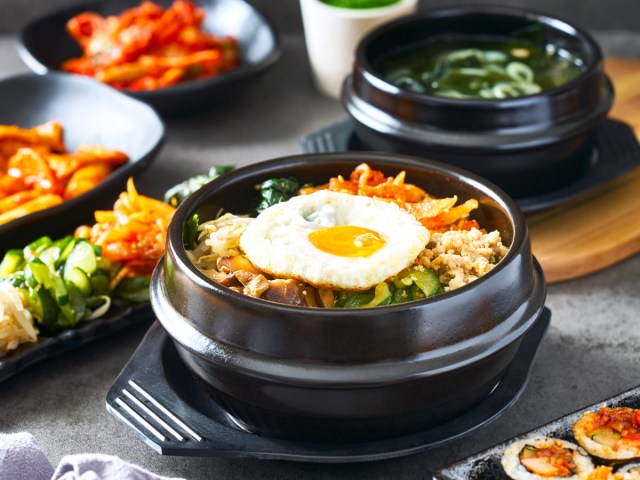 Bowl of bibimbap alongside other traditional Korean dishes