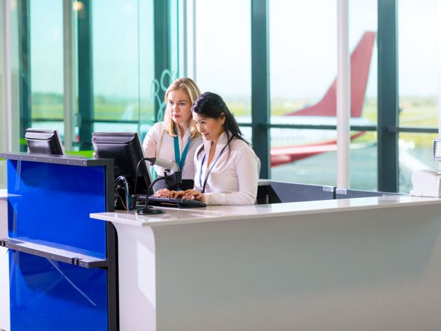 Gate agents working at podium