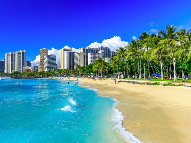 Palm trees, white sands, and skyscrapers of Waikiki Beach