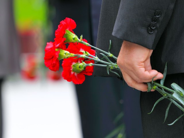 Person holding red flowers