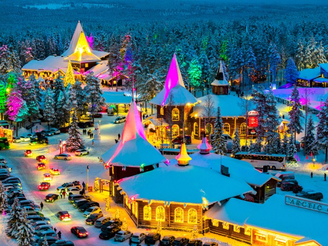 Snowy Santa Claus Village in Finland lit up with Christmas lights