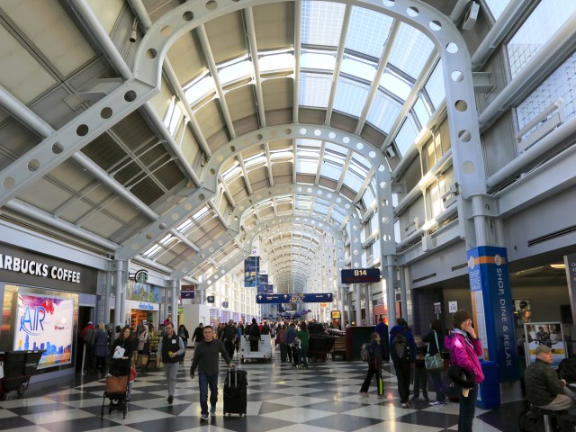Passengers walking past concessions at Chicago O'Hare International Airport