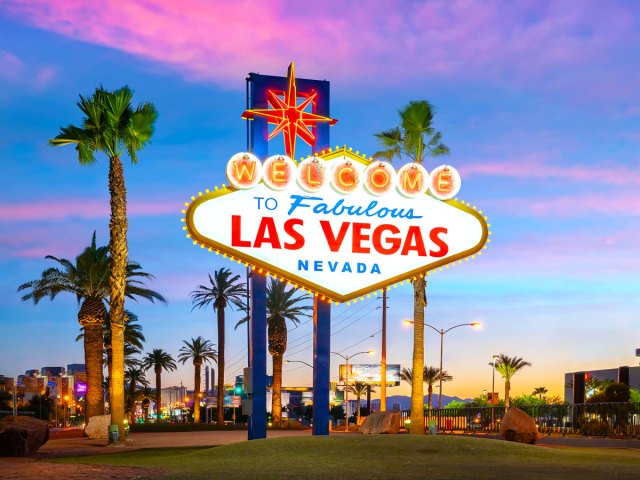 Iconic Las Vegas welcome sign illuminated during sunset
