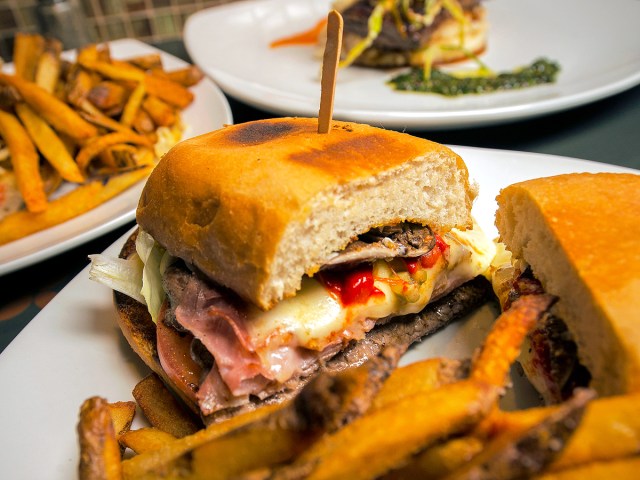 Chivito sandwich on plate with French fries