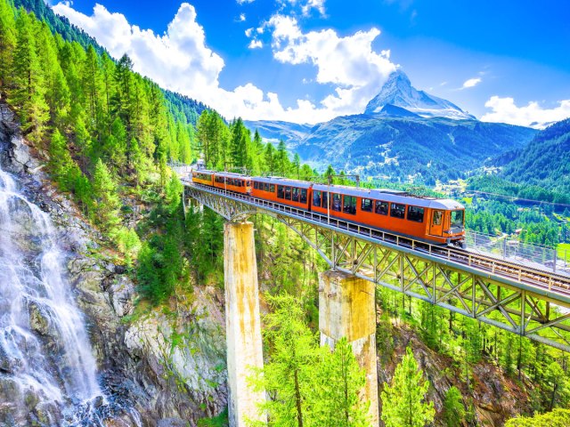 Train on bridge high over mountain pass in Zermatt, Switzerland