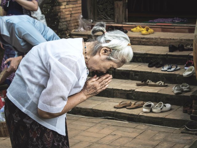 Person bowing in prayer