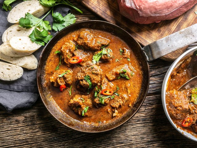 Pot of goulash on cutting board