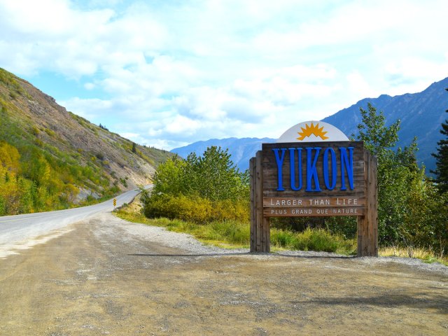 Highway sign welcoming drivers to the Yukon Territory in Canada