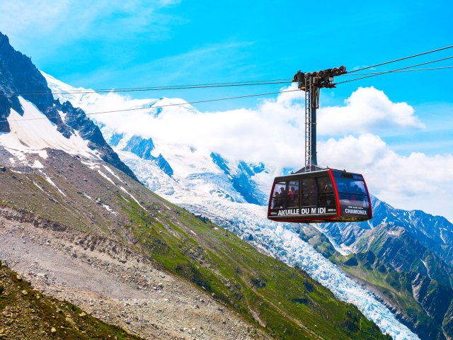 Aiguille du Midi cable car with snow-capped Alps in background