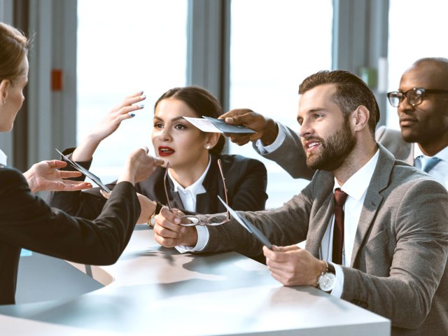 Travelers speaking with airport gate agent