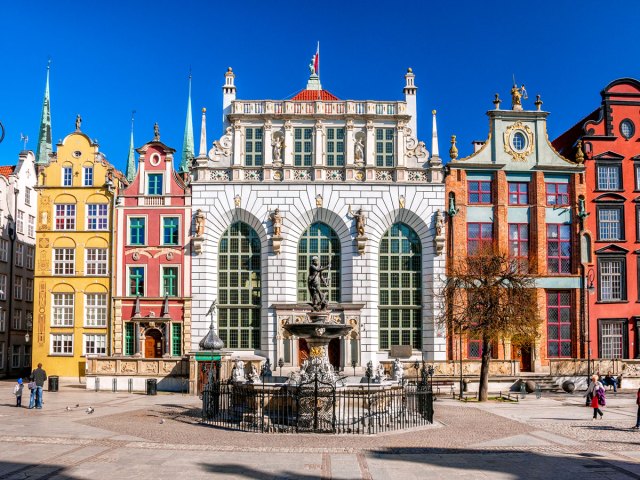 Facade of Artus Court in Gdańsk, with Neptune's Fountain in front