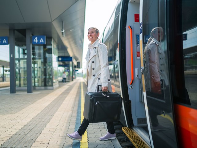 Passenger stepping off train onto platform