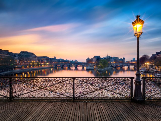 Padlocks attached to Pont des Arts in Paris, seen during sunset