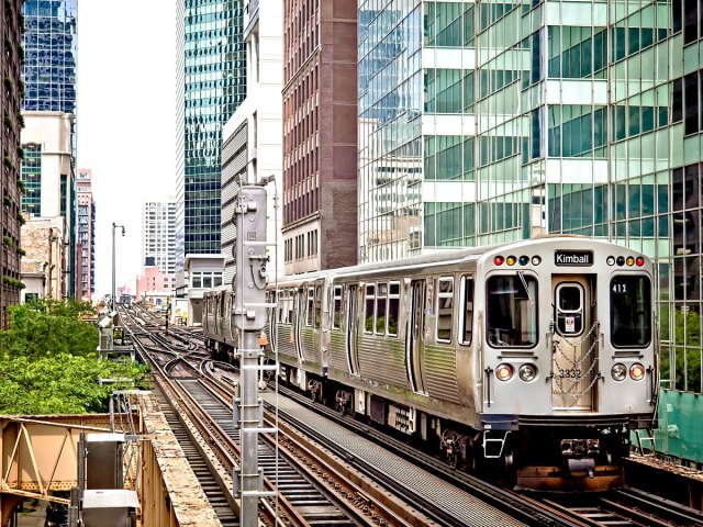 Chicago's "L" train on elevated tracks between high-rises 