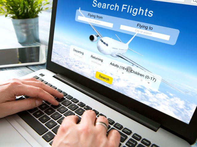 Person using computer to search for flights