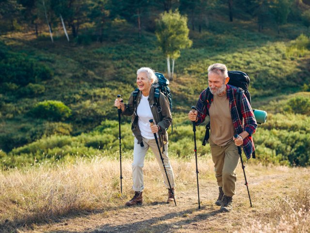 Two people using hiking sticks on trail
