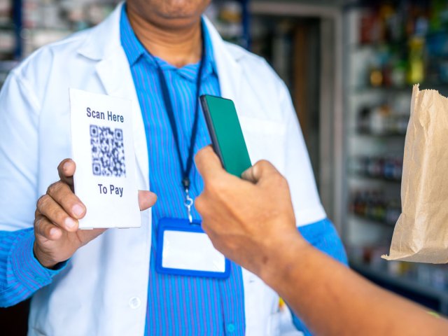 Customer using phone to scan QR code to pay