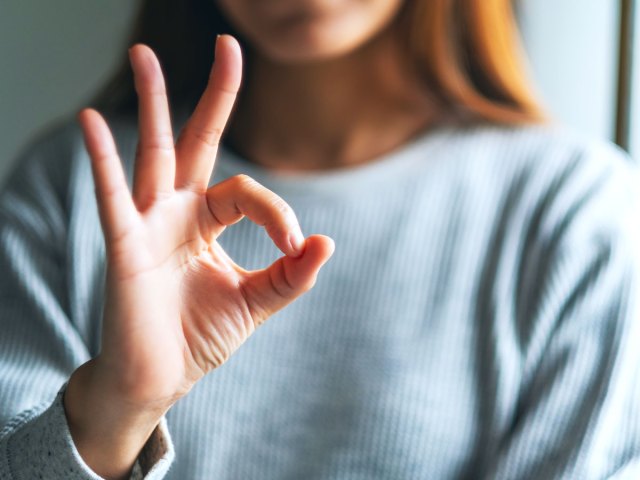 Person making "OK" sign