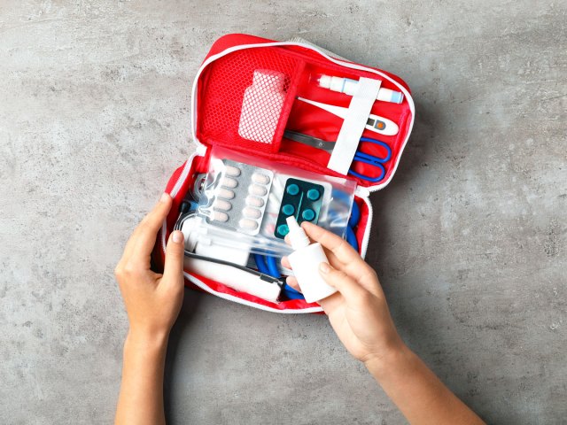Person using first-aid kit